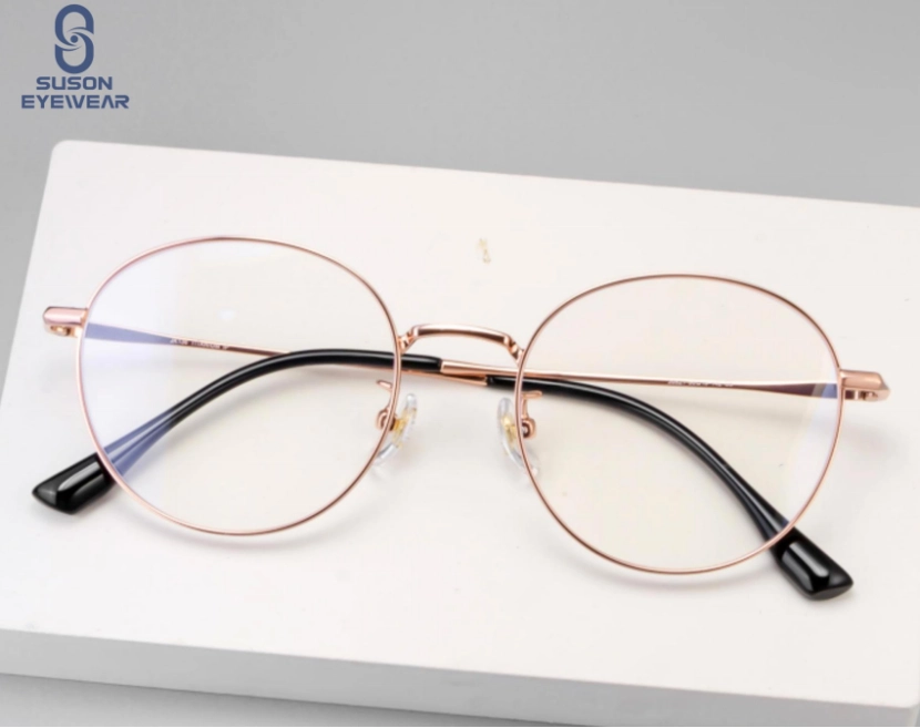 Round thin metal eyeglasses with a rose-gold frame and clear lenses